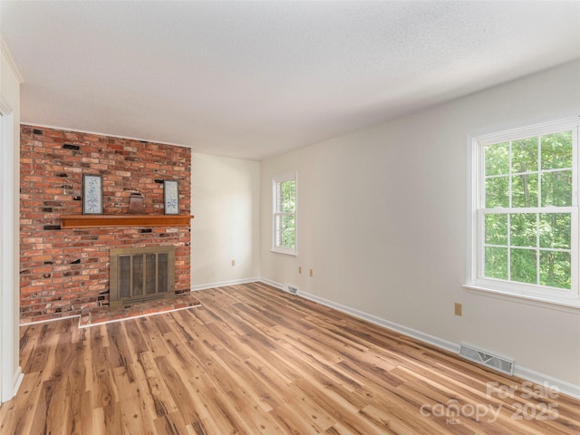 80 Gobblers Knob Dr, Clyde, NC 28721 - unfurnished living room featuring light wood finished floors and a fireplace