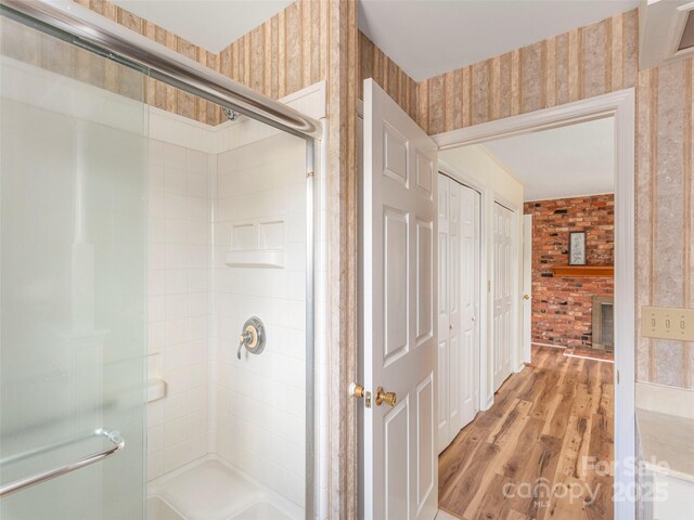 80 Gobblers Knob Dr, Clyde, NC 28721 - bathroom featuring wallpapered walls, a shower stall, and wood finished floors