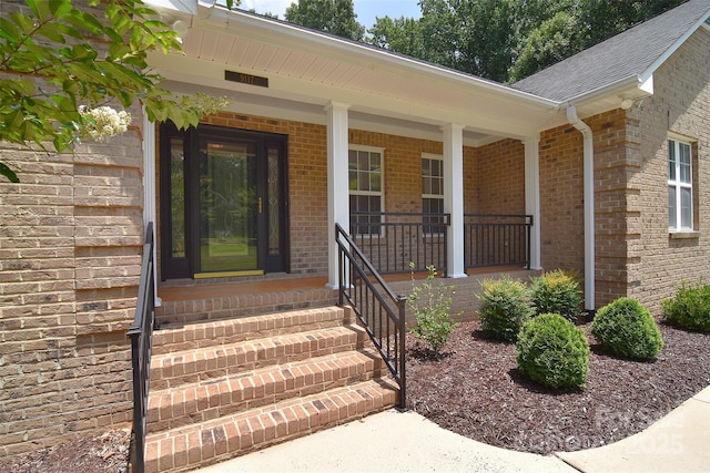 9117 Castle Garden Ln, Charlotte, NC 28215 - entrance to property featuring brick siding, a shingled roof, and covered porch