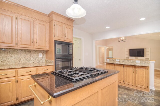 9117 Castle Garden Ln, Charlotte, NC 28215 - kitchen featuring a kitchen island, gas stovetop, light brown cabinetry, black microwave, and recessed lighting