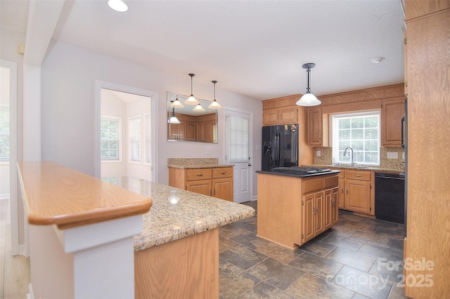 9117 Castle Garden Ln, Charlotte, NC 28215 - kitchen featuring black appliances, a kitchen island, tasteful backsplash, light stone countertops, and pendant lighting