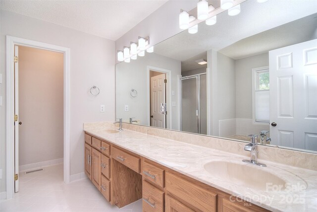 9117 Castle Garden Ln, Charlotte, NC 28215 - full bathroom with double vanity, a stall shower, and tile patterned flooring