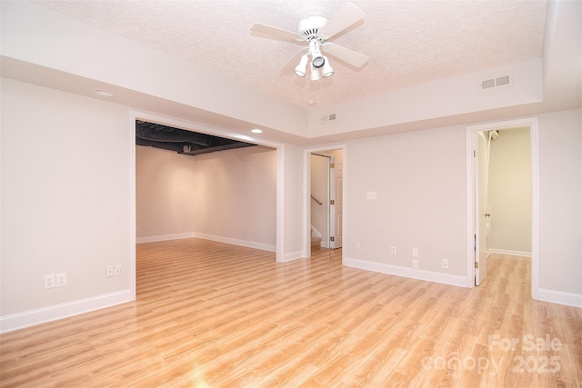 9117 Castle Garden Ln, Charlotte, NC 28215 - empty room featuring a textured ceiling, wood finished floors, ceiling fan, and stairs