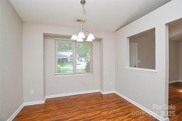 5424 Amado St, Charlotte, NC 28215 - spare room with a chandelier and wood finished floors
