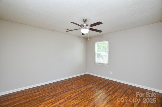 5424 Amado St, Charlotte, NC 28215 - empty room featuring dark wood-style flooring, ceiling fan, and a textured ceiling