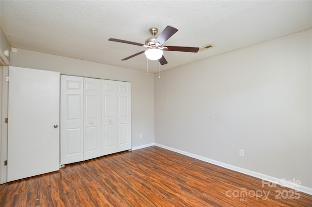 5424 Amado St, Charlotte, NC 28215 - unfurnished bedroom with wood finished floors, a closet, ceiling fan, and a textured ceiling