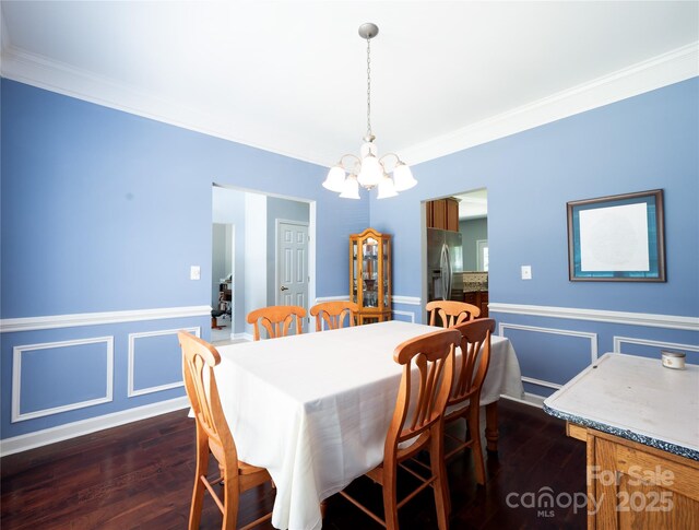 219 Harrowfield Hts, York, SC 29745 - dining space with a chandelier, wainscoting, ornamental molding, dark wood-style floors, and a decorative wall