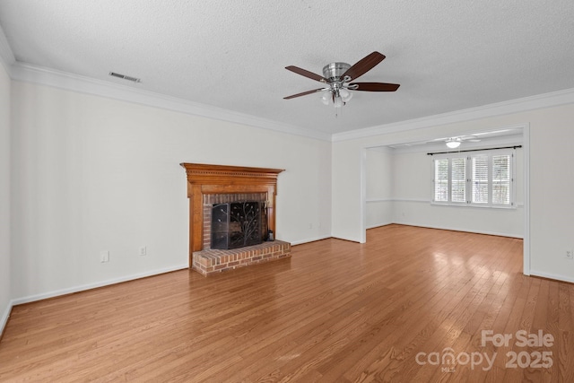 9121 Four Acre Ct, Charlotte, NC 28210 - unfurnished living room featuring a ceiling fan, hardwood / wood-style flooring, a textured ceiling, crown molding, and a fireplace
