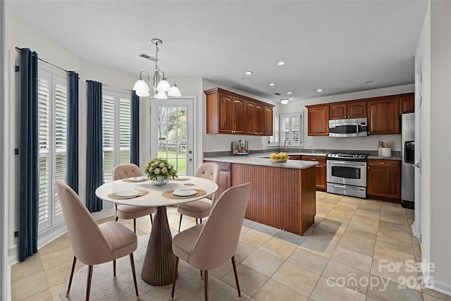 9121 Four Acre Ct, Charlotte, NC 28210 - kitchen with appliances with stainless steel finishes, a chandelier, light tile patterned flooring, recessed lighting, and decorative light fixtures