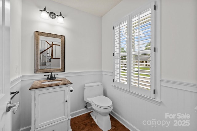 9121 Four Acre Ct, Charlotte, NC 28210 - half bath with wainscoting, wood finished floors, healthy amount of natural light, and vanity