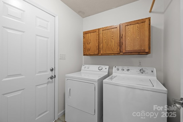 9121 Four Acre Ct, Charlotte, NC 28210 - laundry room featuring washing machine and dryer, cabinet space, and a textured ceiling
