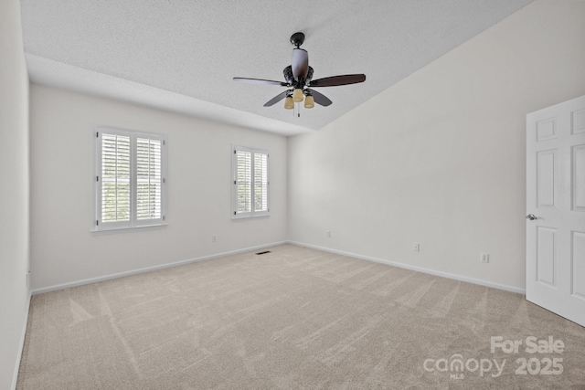 9121 Four Acre Ct, Charlotte, NC 28210 - empty room featuring light colored carpet, vaulted ceiling, ceiling fan, and a textured ceiling