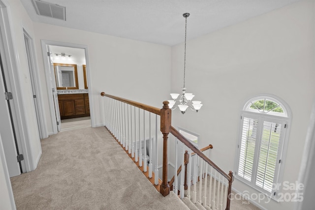 9121 Four Acre Ct, Charlotte, NC 28210 - hall featuring a chandelier, light colored carpet, and an upstairs landing