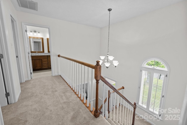 9121 Four Acre Ct, Charlotte, NC 28210 - corridor featuring an upstairs landing, light colored carpet, and a chandelier