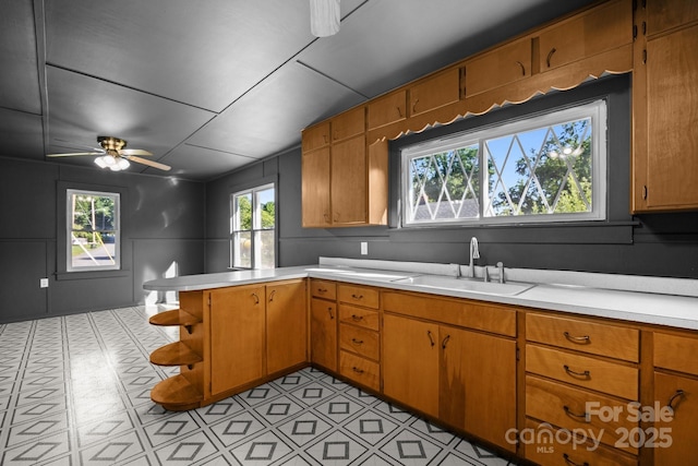 109 Short St, Waynesville, NC 28786 - kitchen featuring light countertops, open shelves, a peninsula, a ceiling fan, and brown cabinets