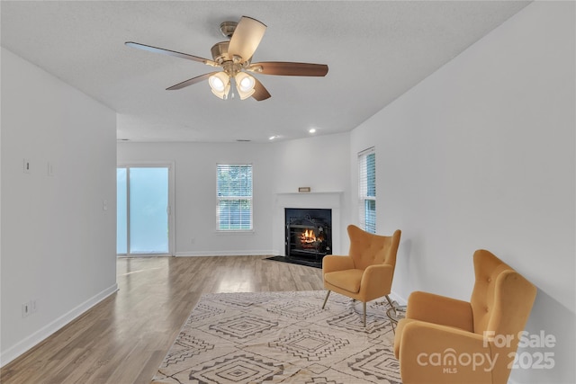 11407 Lenswood Ct, Charlotte, NC 28214 - living room with light wood-style flooring, a fireplace with flush hearth, and ceiling fan
