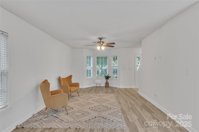 11407 Lenswood Ct, Charlotte, NC 28214 - living area with light wood finished floors and ceiling fan