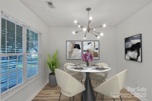 11407 Lenswood Ct, Charlotte, NC 28214 - dining area featuring a chandelier and wood finished floors