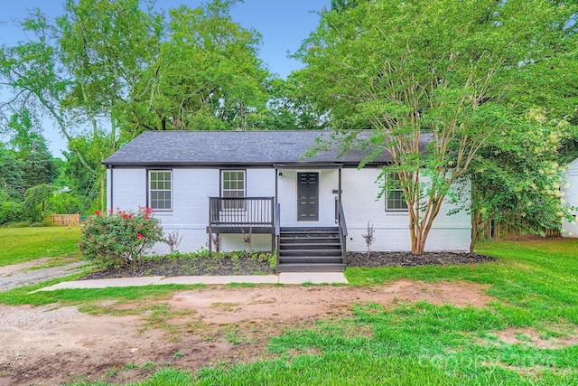 1224 E Woodlawn Rd, Charlotte, NC 28209 - ranch-style home with brick siding, a front yard, roof with shingles, and a porch
