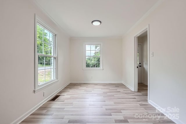 1224 E Woodlawn Rd, Charlotte, NC 28209 - spare room featuring plenty of natural light, light wood-style flooring, and crown molding