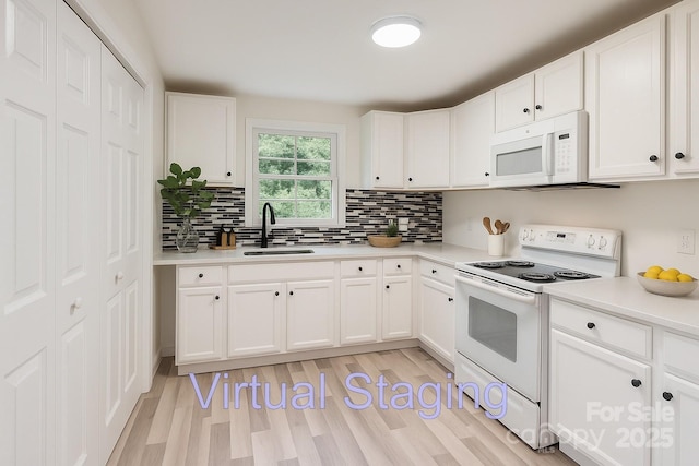 1224 E Woodlawn Rd, Charlotte, NC 28209 - kitchen with white appliances, backsplash, white cabinetry, light wood-style floors, and light countertops