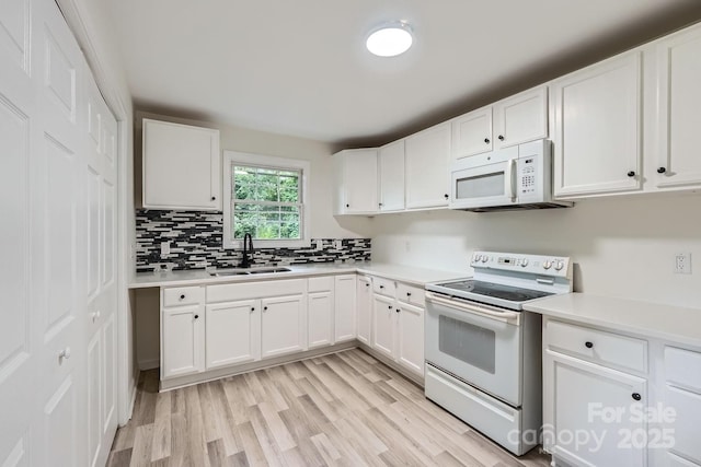1224 E Woodlawn Rd, Charlotte, NC 28209 - kitchen with white appliances, light countertops, and light wood-type flooring