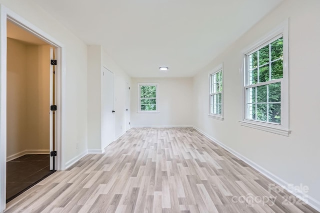 1224 E Woodlawn Rd, Charlotte, NC 28209 - empty room featuring light wood finished floors and baseboards