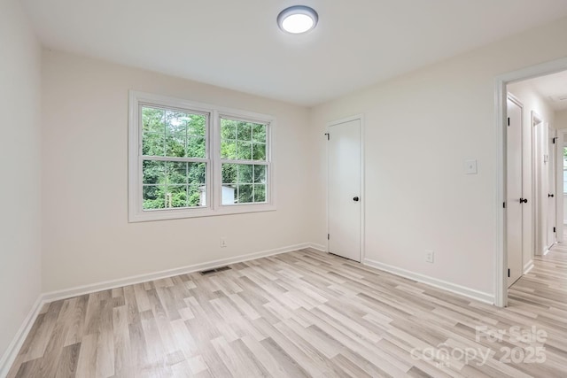 1224 E Woodlawn Rd, Charlotte, NC 28209 - unfurnished bedroom featuring light wood-style flooring and baseboards