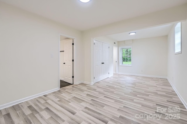 1224 E Woodlawn Rd, Charlotte, NC 28209 - empty room with light wood-style floors and baseboards