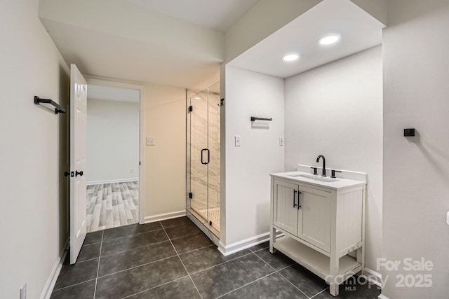 1224 E Woodlawn Rd, Charlotte, NC 28209 - bathroom with a shower stall, tile patterned flooring, vanity, and recessed lighting