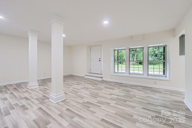 1224 E Woodlawn Rd, Charlotte, NC 28209 - unfurnished living room featuring ornate columns, light wood finished floors, recessed lighting, and electric panel