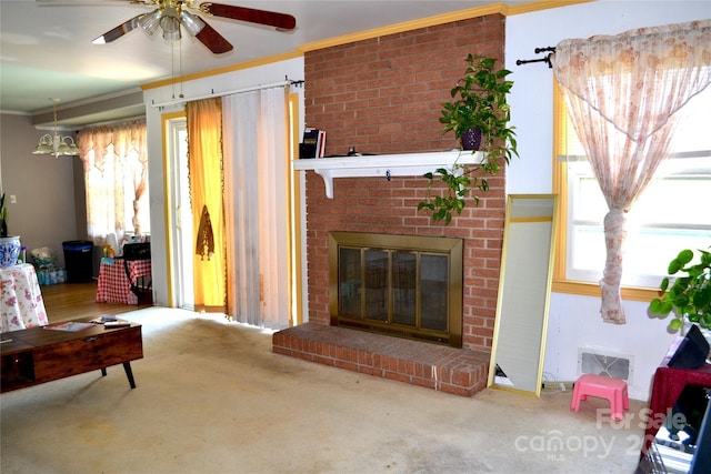 405 Wesley Heights Dr, Albemarle, NC 28001 - carpeted living room featuring plenty of natural light, ceiling fan, a brick fireplace, and crown molding