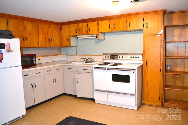 405 Wesley Heights Dr, Albemarle, NC 28001 - kitchen with white appliances, light countertops, light floors, and brown cabinets