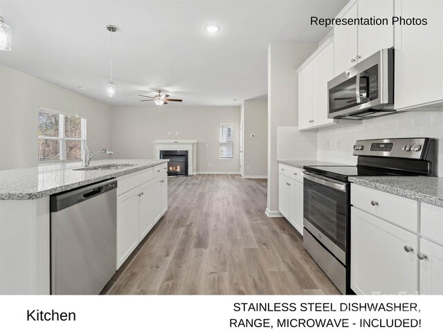 217 Lake George Dr, Shelby, NC 28152 - kitchen with stainless steel appliances, ceiling fan, tasteful backsplash, healthy amount of natural light, and recessed lighting