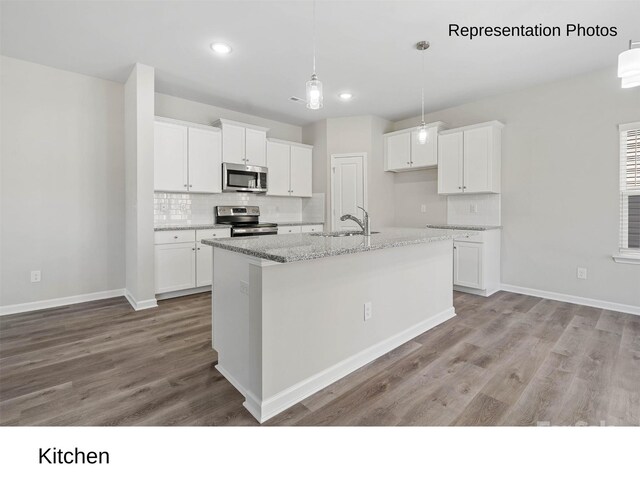 217 Lake George Dr, Shelby, NC 28152 - kitchen featuring appliances with stainless steel finishes, tasteful backsplash, light wood-type flooring, white cabinetry, and a kitchen island with sink