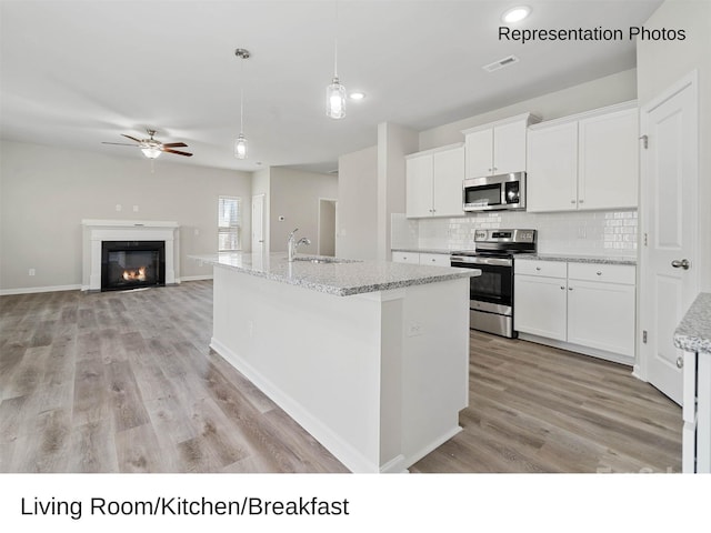 217 Lake George Dr, Shelby, NC 28152 - kitchen with appliances with stainless steel finishes, ceiling fan, decorative backsplash, light wood finished floors, and white cabinets