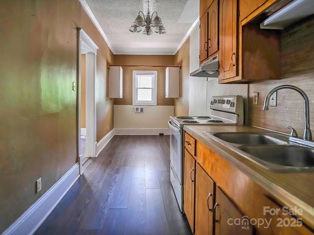 307 S Jacob St, Cherryville, NC 28021 - kitchen featuring electric stove, under cabinet range hood, brown cabinetry, a chandelier, and dark wood-style floors