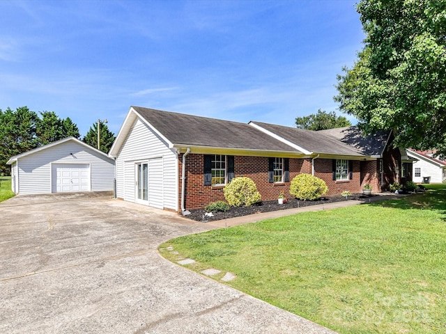 5105 Hampton Meadows Rd, Monroe, NC 28110 - ranch-style home featuring concrete driveway, a detached garage, brick siding, an outbuilding, and a front yard