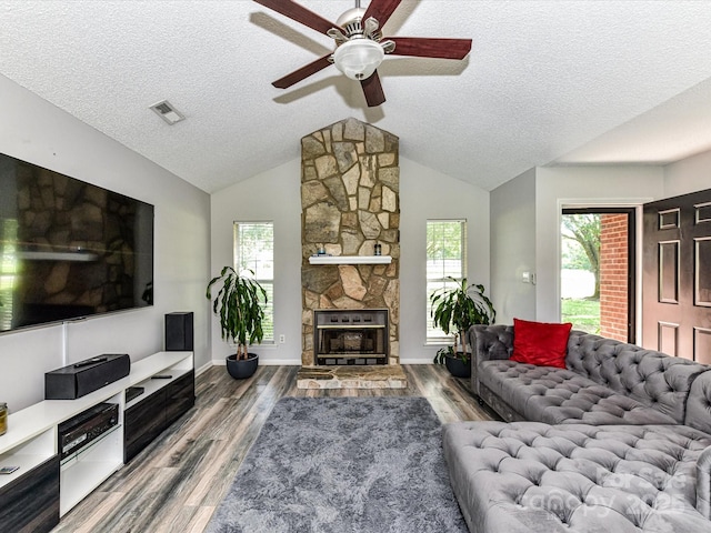 5105 Hampton Meadows Rd, Monroe, NC 28110 - living room with ceiling fan, wood finished floors, a textured ceiling, lofted ceiling, and a fireplace