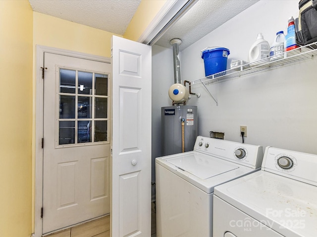 5105 Hampton Meadows Rd, Monroe, NC 28110 - washroom with water heater, independent washer and dryer, and a textured ceiling