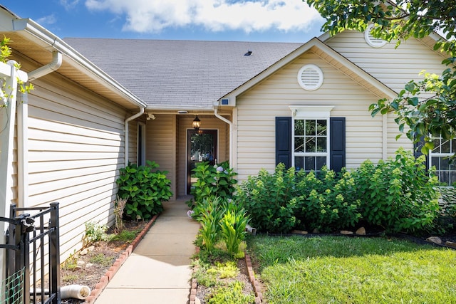 5806 Autumn Trace Ln, Indian Trail, NC 28079 - view of exterior entry featuring a shingled roof and a yard