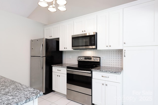 5806 Autumn Trace Ln, Indian Trail, NC 28079 - kitchen with stainless steel appliances, backsplash, white cabinets, a chandelier, and light tile patterned flooring