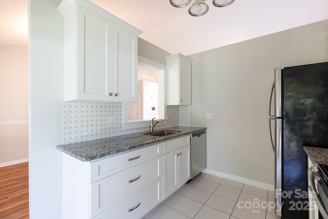 5806 Autumn Trace Ln, Indian Trail, NC 28079 - kitchen with appliances with stainless steel finishes, tasteful backsplash, white cabinetry, stone countertops, and light tile patterned floors