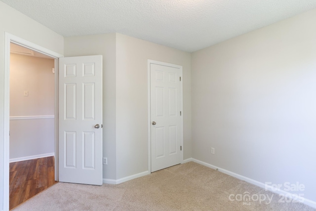 5806 Autumn Trace Ln, Indian Trail, NC 28079 - unfurnished bedroom featuring carpet and a textured ceiling
