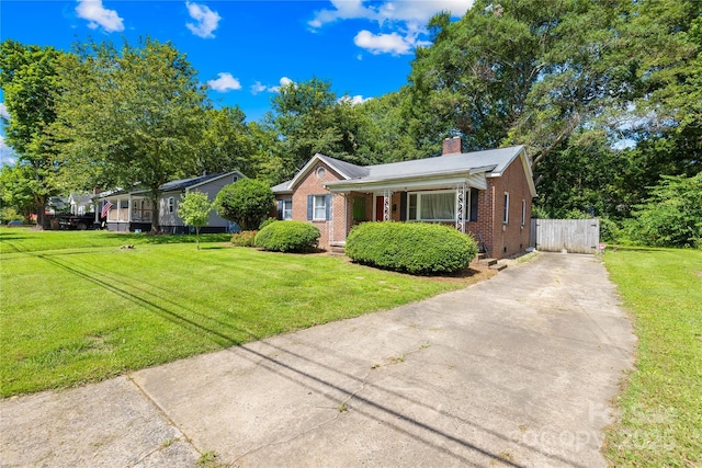 506 Gold St, Shelby, NC 28150 - view of front of home featuring brick siding, driveway, a chimney, and a front yard