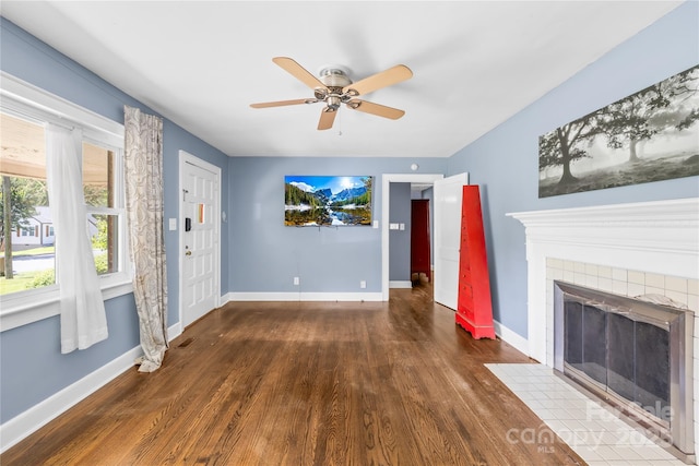 506 Gold St, Shelby, NC 28150 - unfurnished living room featuring wood finished floors, a ceiling fan, and a tile fireplace
