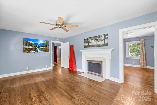 506 Gold St, Shelby, NC 28150 - unfurnished living room with a ceiling fan, wood finished floors, and a tiled fireplace