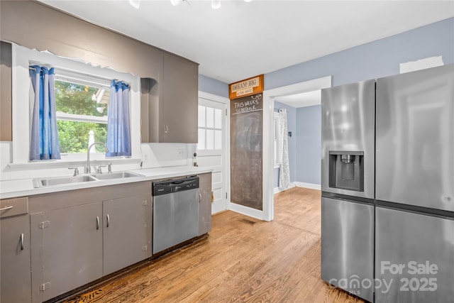 506 Gold St, Shelby, NC 28150 - kitchen featuring appliances with stainless steel finishes, light wood-style flooring, gray cabinets, and light countertops