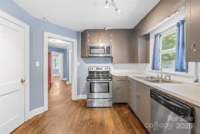 506 Gold St, Shelby, NC 28150 - kitchen with appliances with stainless steel finishes, gray cabinetry, dark wood finished floors, and healthy amount of natural light