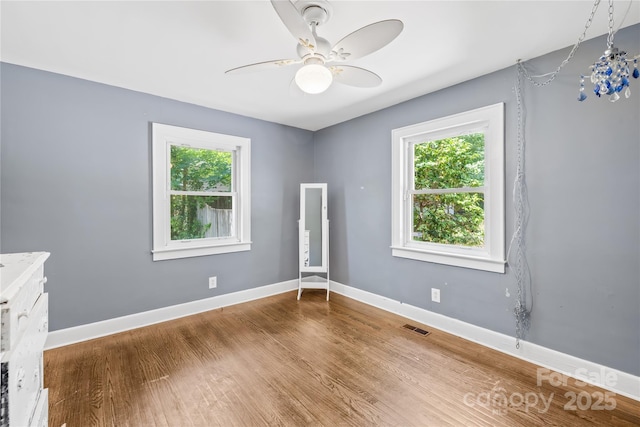 506 Gold St, Shelby, NC 28150 - empty room with plenty of natural light, ceiling fan, and wood finished floors